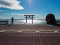 Torii in lake with blue sky background