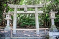 Torii gate and stone lamps in a park in Fukuoka Royalty Free Stock Photo