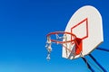 A torn basketball basket against the blue sky. Royalty Free Stock Photo