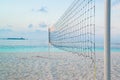 Torn beach volleyball net at tropical beach