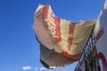 Torn Billboard developing in the air against the blue sky