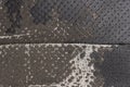 Torn black fabric on a leather office armchair background texture. worn upholstery chair Royalty Free Stock Photo