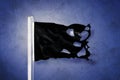 Torn black flag flying against grunge background