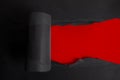 Torn black paper on red background. Top view Royalty Free Stock Photo