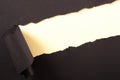 Torn black paper strip yellow background diagonal angle