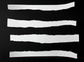 torn blank white paper strips against a black background Royalty Free Stock Photo