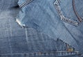 Torn blue denim cotton fabric trousers - jeans fashion mending or repair concept, flat lay top view Royalty Free Stock Photo