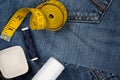 Torn blue denim cotton fabric trousers with tailor`s tools - jeans fashion mending or repair concept, flat lay top view from abov Royalty Free Stock Photo