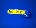 Torn blue Paper and space for Just Do it message text with yellow paper background , motivate and cheering concept