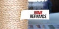 Torn brown paper on white surface with text Home refinance Royalty Free Stock Photo