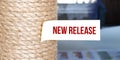 Torn brown paper on white surface with text NEW RELEASE word Royalty Free Stock Photo