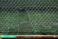 Torn chain link fence. Hole in mesh netting Royalty Free Stock Photo