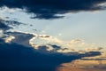 Torn cloud at sunset with shadows. Backlit by the bright yellow sun Royalty Free Stock Photo