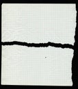 Torn and creased old notebook page with square grid