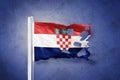 Torn flag of Croatia flying against grunge background Royalty Free Stock Photo