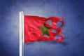 Torn flag of Morocco flying against grunge background Royalty Free Stock Photo