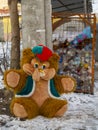 A torn furry, toy bear thrown into a landfill
