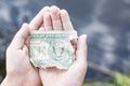 Torn half of a dollar bill in a child`s hand Royalty Free Stock Photo