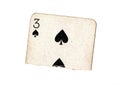 A torn half of a vintage three of spades playing card. Royalty Free Stock Photo