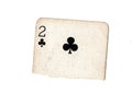 A torn half of a vintage two of clubs playing card.