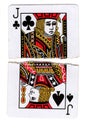 Torn halves of a jack of clubs and a jack of spades playing cards.