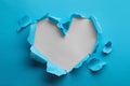 Torn heart shaped hole in light blue paper on white background Royalty Free Stock Photo