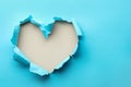 Torn heart shaped hole in light blue paper on white background, space for text Royalty Free Stock Photo