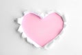 Torn heart shaped hole in white paper. Pink space for text Royalty Free Stock Photo