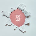 Torn hole in the white paper with text Open Your Mind. Concept of seeing the world, traveling, open your mind, creativity Royalty Free Stock Photo
