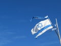 Torn Israeli flag in blue sky