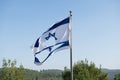 Torn Israeli flag flutters in the wind