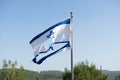 Torn Israeli flag flutters in the wind