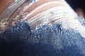 holes on jeans, threads stick out blue jeans worn out, Torn jeans on the legs close-up Royalty Free Stock Photo