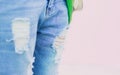 Torn jeans on a pink background so close back focus