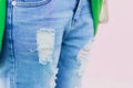 Torn jeans on a pink background so close front focus