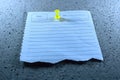 Torn lined note paper with date and theme fields pinned on gray styrofoam surface Royalty Free Stock Photo