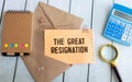 Torn notebook paper on gray copy space background with text THE GREAT RESIGNATION Royalty Free Stock Photo