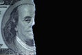 Torn one hundred US Dollar bill against black background. Copy space Royalty Free Stock Photo