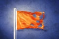 Torn Orange flag flying against grunge background