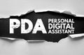 Torn paper effect showing bold PDA acronym with Personal Digital Assistant text. Concept design representing mobile computing, Royalty Free Stock Photo