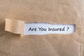 Torn paper envelope with word are you insured. Insurance concept