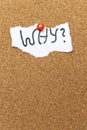 A torn paper note with the handwritten word WHY? pinned on a corkboard. This image represents questioning, curiosity, an Royalty Free Stock Photo