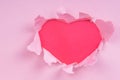 Torn paper red heart on a pink background Royalty Free Stock Photo