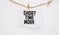 torn paper revealing a document with the text SHORT TIME WORK Royalty Free Stock Photo