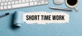 Torn paper revealing the text SHORT TIME WORK Royalty Free Stock Photo