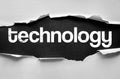Torn paper revealing the word Technology in bold distressed font, representing modern innovations, digital progress, and advanced Royalty Free Stock Photo