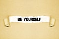 Torn paper revealing words BE YOURSELF Royalty Free Stock Photo