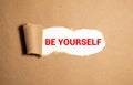 Torn paper revealing words BE YOURSELF, Idea for how to love yourself, Investing in knowledge Royalty Free Stock Photo