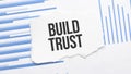 Torn Paper With Text BUILD TRUST On Bar Graph Report