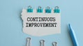 Torn paper with text Continuous Improvement. Royalty Free Stock Photo